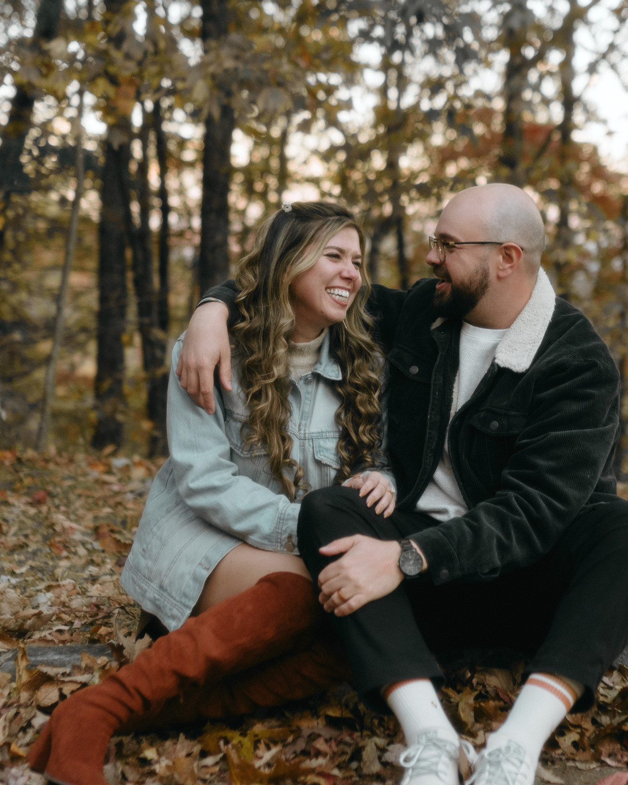Sitting on the forest floor in a drift of brown leaves, in denim and corduroy, laughing at each other.